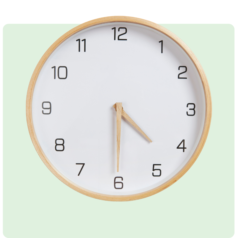 A round wall clock with a wooden frame and clear white face is shown against a light green background, reminiscent of the clarity essential in financial planning. It displays Arabic numerals, and the hands indicate 10:10.