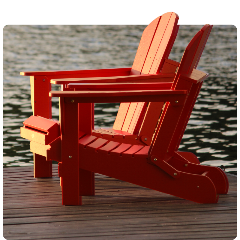 Two red muskoka chairs on the dock